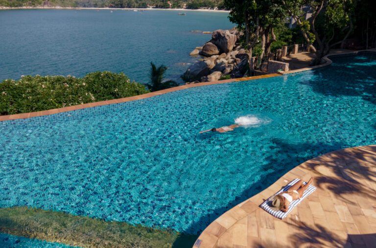 sunbathing by the infinity-edge swimming pool with ocean view Koh Phangan